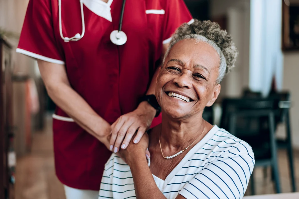 Senior client smiling with healthcare professional
